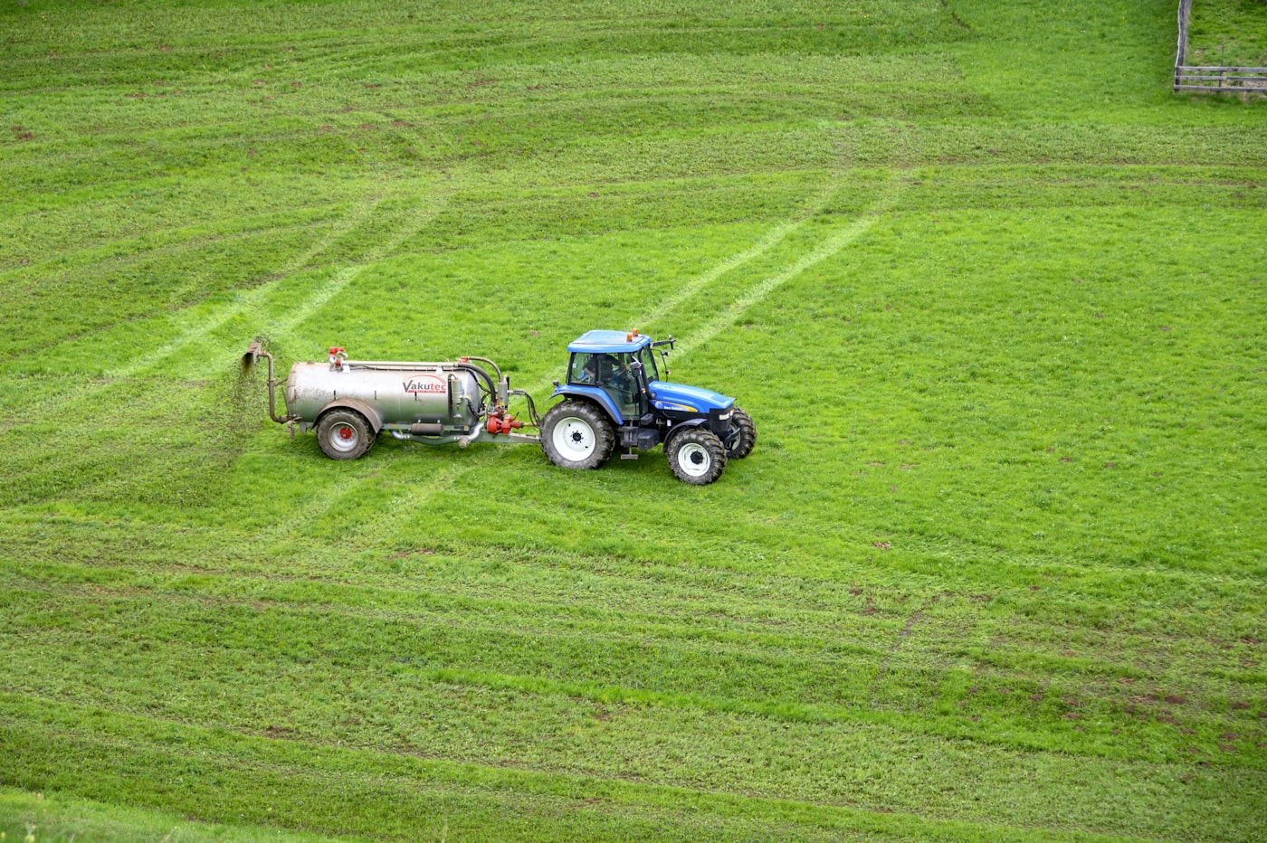 Tractor-drawn water tanker on a field